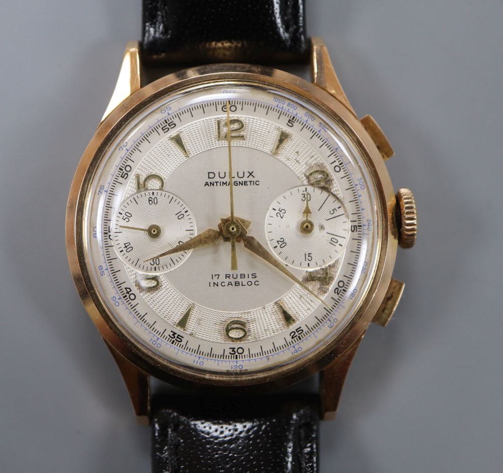 A gentlemans 1950s 18k Dulux chronograph manual wind wrist watch, on later associated strap.